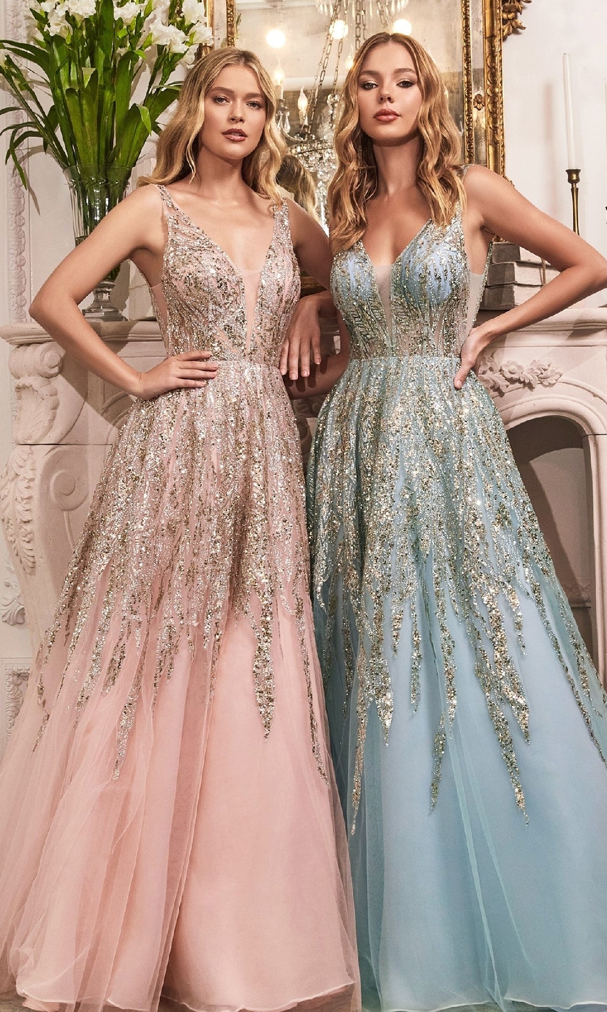 Two women stand together in an elegant room, both wearing Ladivine C135 Sheer-Sides Long Glitter Prom Dresses—one in blush pink, the other in light blue—each featuring beautiful sequin detailing.